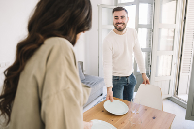 happy man and woman serving table