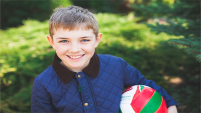 happy smiling child holding a football