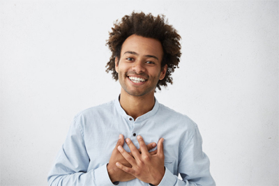 happy smiling man holding his chest