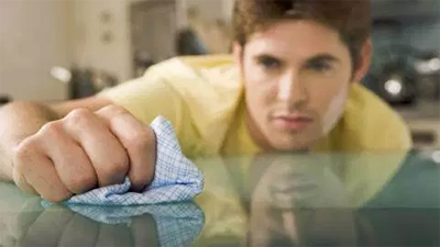 man with ocd wiping the table